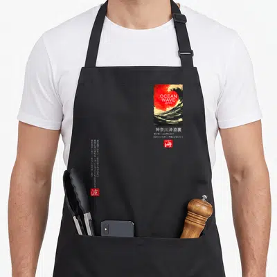 Tablier de cuisine noir orné d'une illustration de grande vague japonaise et d'un disque solaire rouge.