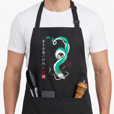 Tablier de cuisine noir avec dragon vert en style aquarelle et calligraphie japonaise verticale à gauche.