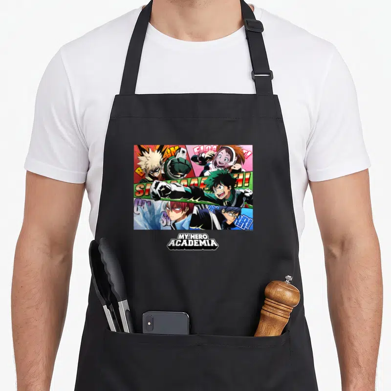 Tablier de cuisine noir avec une illustration colorée de la classe 1-A et le logo My Hero Academia en bas.