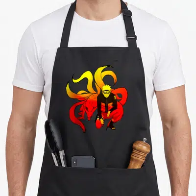 Tablier de cuisine noir avec Naruto crouching entouré des tails orange et rouge vif.