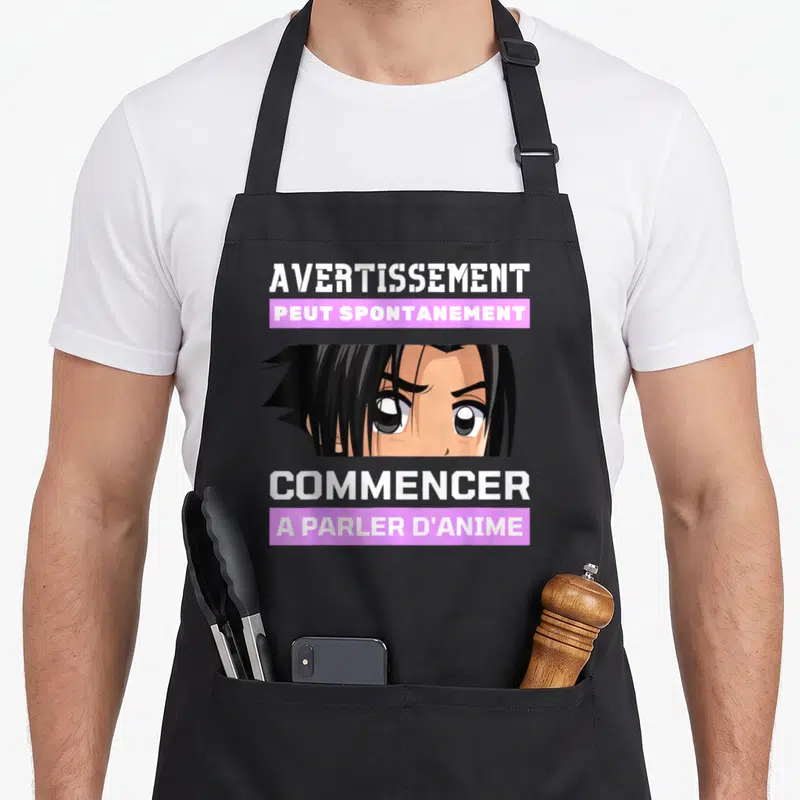 Tablier de cuisine noir avec un personnage d'animation et le texte Avertissement peut spontanément commencer à parler d'anime.