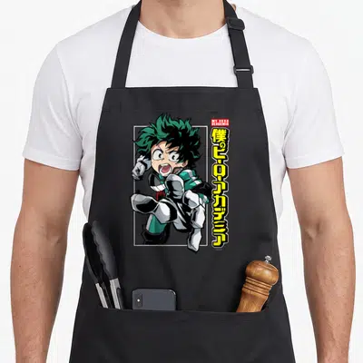 Tablier de cuisine noir avec illustration de Deku en course et texte kanji jaune vertical à droite.