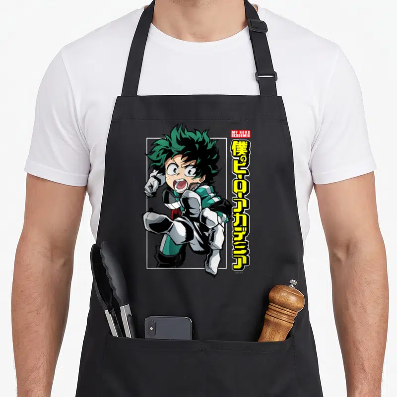 Tablier de cuisine noir avec illustration de Deku en course et texte kanji jaune vertical à droite.