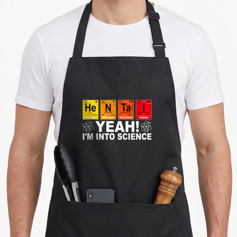 Tablier de cuisine noir avec quatre cases chimiques colorées et le texte yeah i'm into science en blanc.