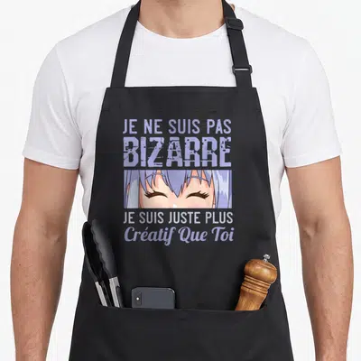Tablier de cuisine noir avec illustration manga aux cheveux bleus et texte humoristique en violet clair.