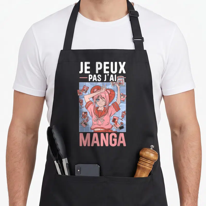 Tablier de cuisine noir avec une illustration d'une fille aux cheveux roses tenant des mangas et le texte Je peux pas j'ai manga.