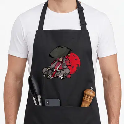 Tablier de cuisine noir avec illustration d'un samouraï assis tenant un katana devant un soleil rouge.