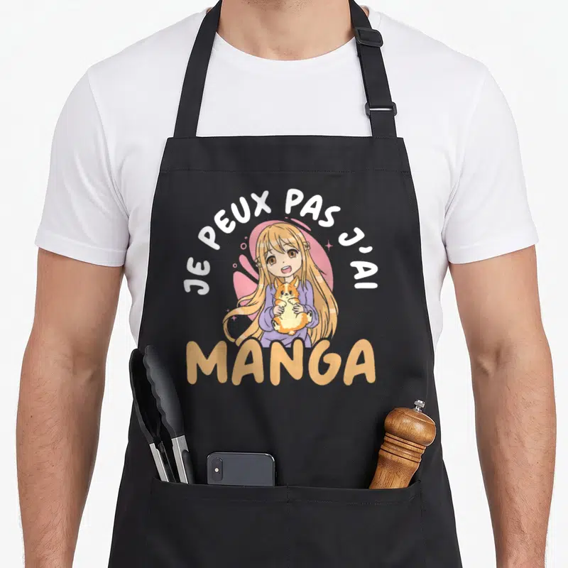 Tablier de cuisine noir avec une illustration de fille anime tenant un chat et le texte Je peux pas j'ai manga.