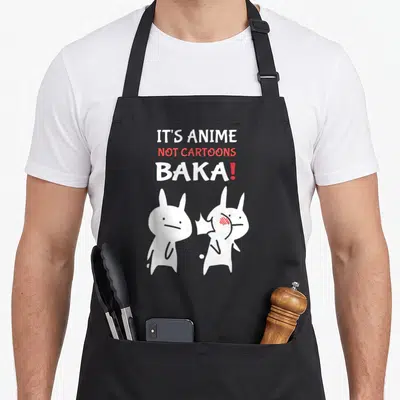 Tablier de cuisine noir avec deux lapins blancs stylisés et le texte It's Not Cartoons Baka en blanc et rouge.