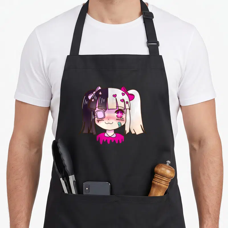 Tablier de cuisine noir avec illustration d'une fille anime aux cheveux bicolores et inscriptions yami kawaii.