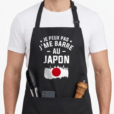 Tablier de cuisine noir avec texte blanc et drapeau japonais rouge et blanc stylisé