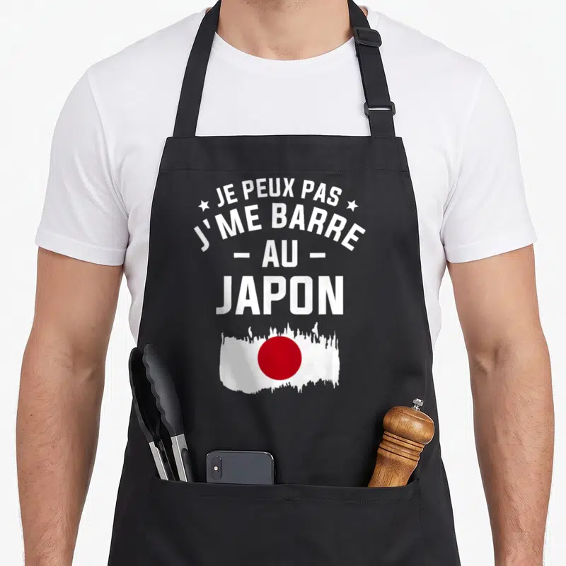 Tablier de cuisine noir avec texte blanc et drapeau japonais rouge et blanc stylisé