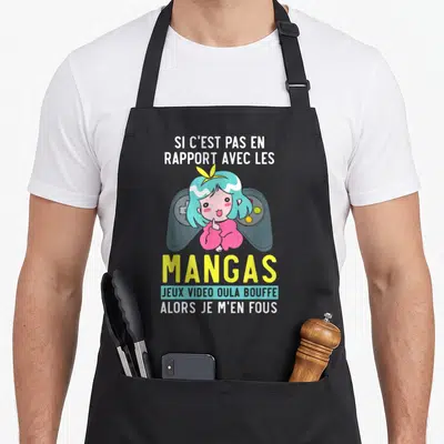 Tablier de cuisine noir avec une illustration kawaii et un texte humoristique sur les passions manga et jeux vidéo.