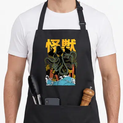 Tablier de cuisine noir avec une illustration de Cthulhu au Japon en style manga vintage et vagues bleues.
