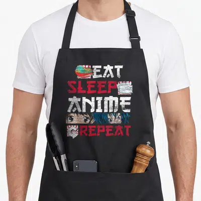 Tablier de cuisine noir avec les mots Eat Sleep Anime Repeat, un bol de ramen et des yeux de personnages manga.