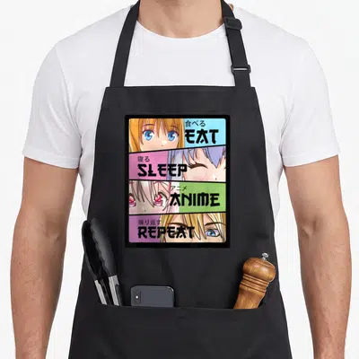 Tablier de cuisine noir avec quatre bandes colorées illustrant des yeux d'anime et les mots Eat Sleep Anime Repeat en anglais et japonais.