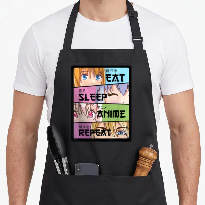 Tablier de cuisine noir avec quatre bandes colorées illustrant des yeux d'anime et les mots Eat Sleep Anime Repeat en anglais et japonais.
