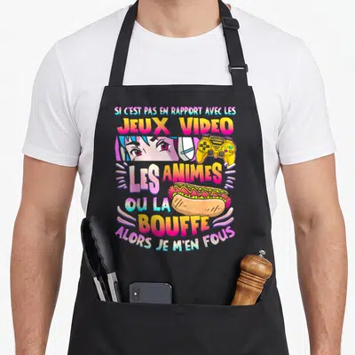 Tablier de cuisine noir avec texte coloré, yeux d'animé, manette jaune et hot-dog.