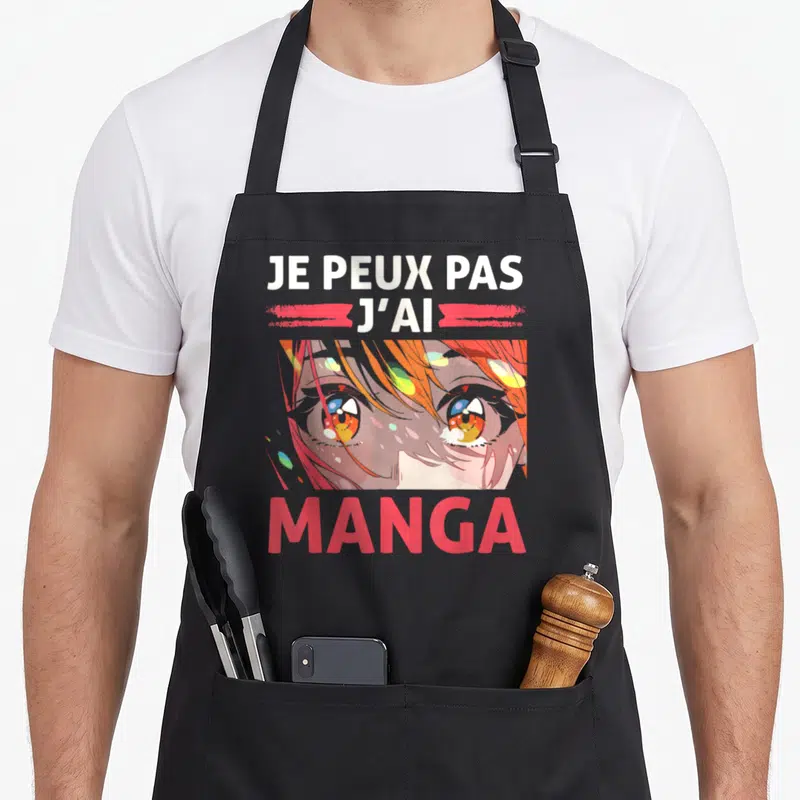 Tablier de cuisine noir avec illustration de visage aux grands yeux colorés et texte blanc et rose Je peux pas j'ai manga.