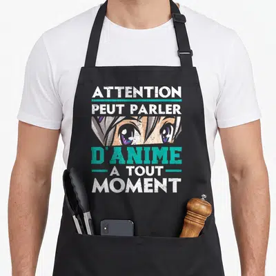 Tablier de cuisine noir avec illustration d'yeux anime et texte blanc et turquoise.
