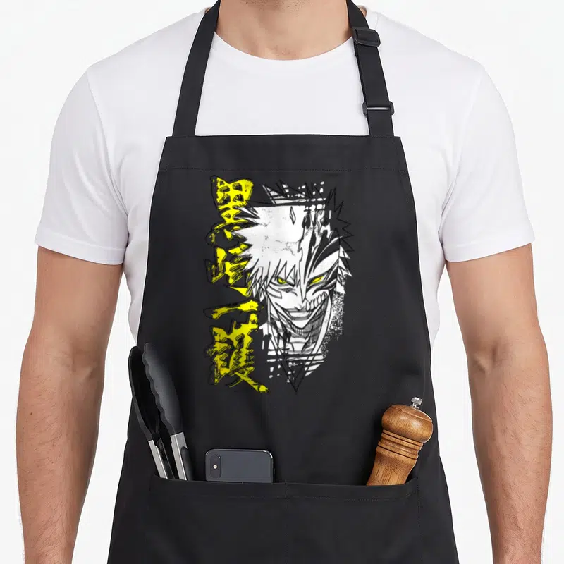 Tablier de cuisine noir avec illustration d'Ichigo Hollow et caractères japonais jaunes sur le devant.
