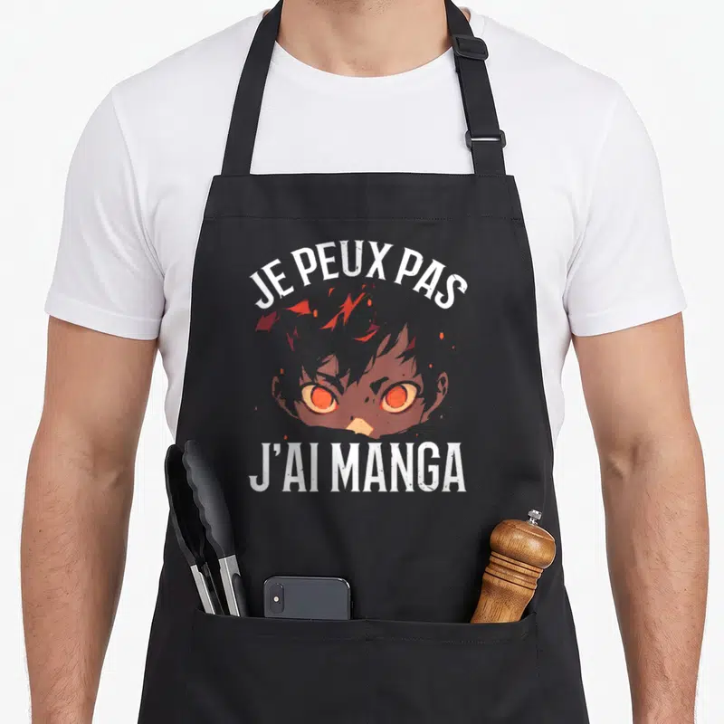 Tablier de cuisine noir avec visage aux yeux oranges et texte blanc Je peux pas j'ai manga