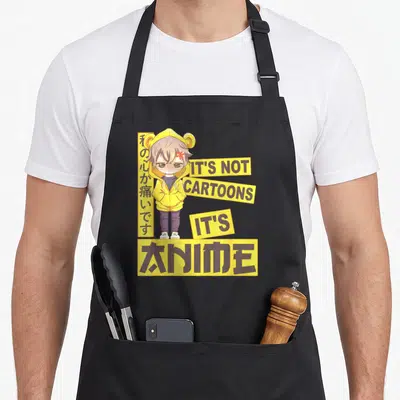 Tablier de cuisine noir avec un personnage de manga en pull jaune et le texte It's not cartoons it's anime.