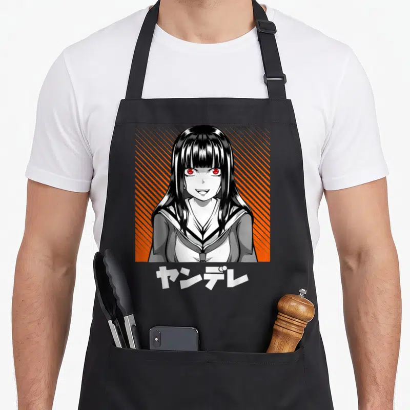 Tablier de cuisine noir avec illustration d'une fille Yandere aux yeux rouges et texte Kanji blanc.