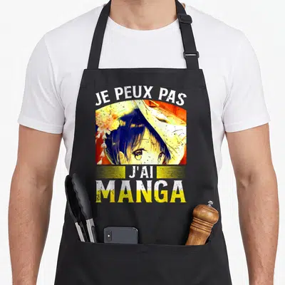 Tablier de cuisine noir avec illustration anime et texte Je peux pas j'ai manga en blanc et jaune.