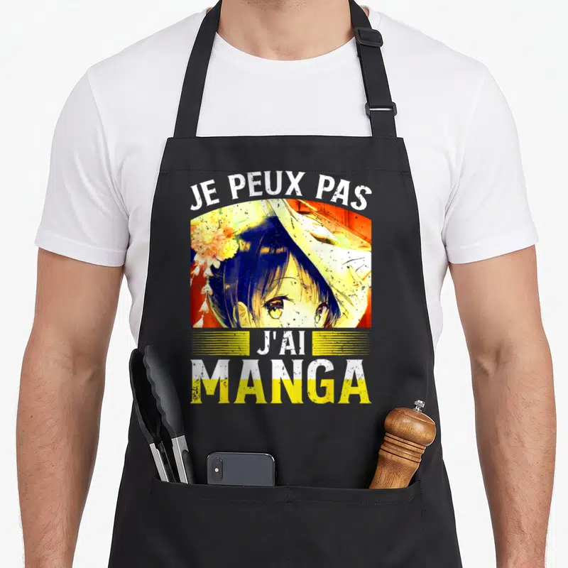 Tablier de cuisine noir avec illustration anime et texte Je peux pas j'ai manga en blanc et jaune.