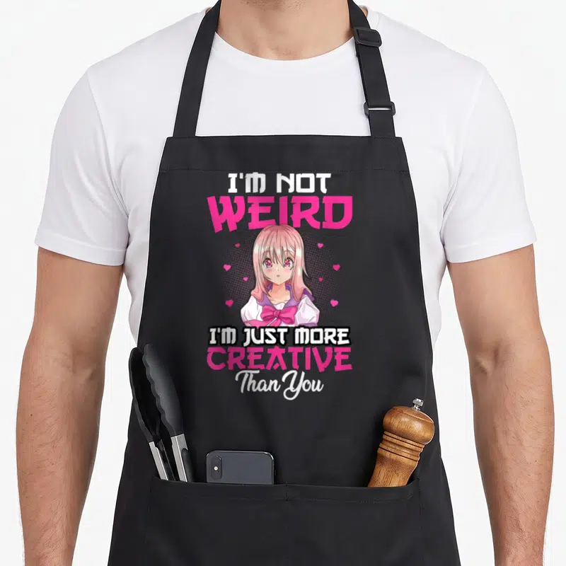 Tablier de cuisine noir avec une illustration anime rose et le texte I'm Not Weird I'm Just More Creative Than You.