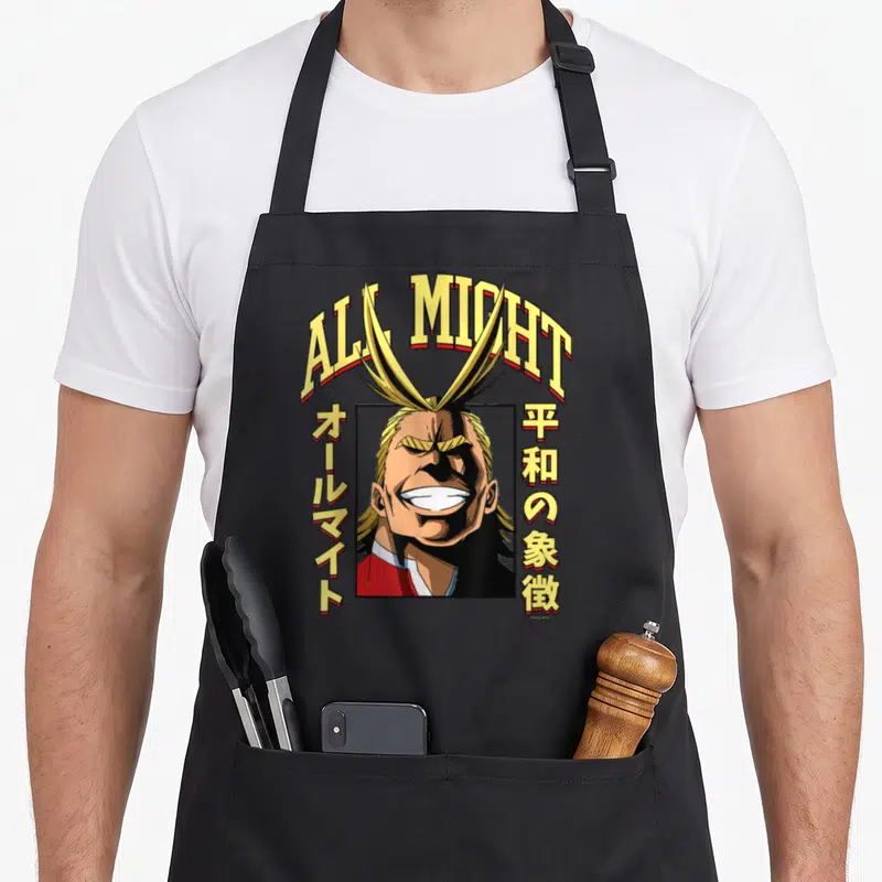 Tablier de cuisine noir avec portrait d'All Might et texte ALL MIGHT en lettres jaunes.