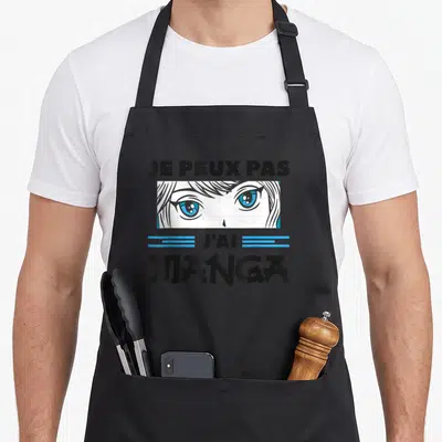Tablier de cuisine noir avec une illustration de yeux bleus et le texte Je peux pas j'ai manga imprimé en noir et bleu.