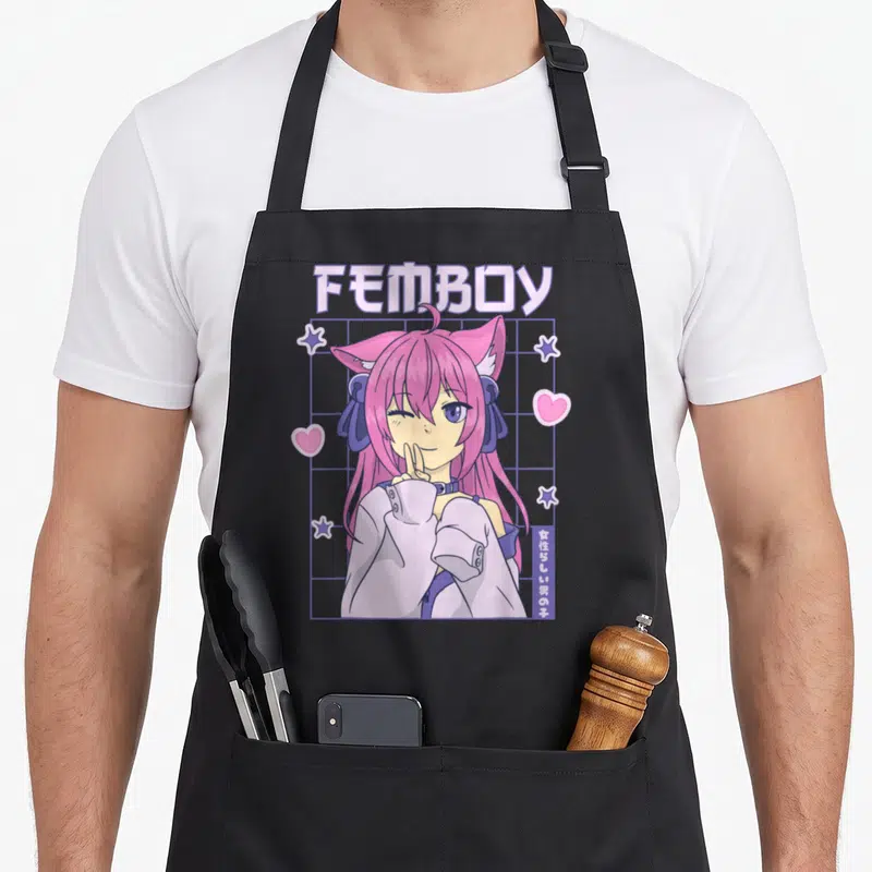 Tablier de cuisine noir avec illustration d'un personnage femboy aux cheveux roses et oreilles de chat.