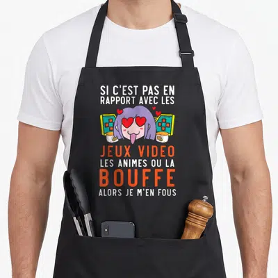 Tablier de cuisine noir avec une illustration manga de fille aux yeux de cœur, sushi et console de jeu vidéo.