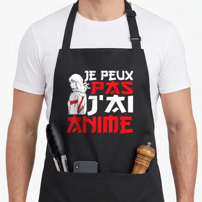 Tablier de cuisine noir avec une illustration de fille aux cheveux blancs et le texte Je peux pas j'ai anime en blanc et rouge.