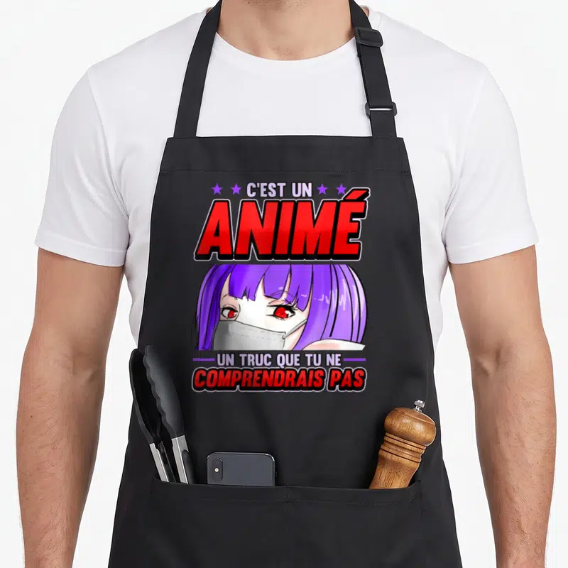 Tablier de cuisine noir avec illustration d'une fille aux cheveux violets portant un masque médical blanc et le texte C'est un animé en rouge.