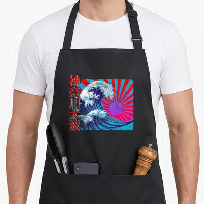 Tablier de cuisine noir avec une illustration colorée d'une grande vague japonaise et des caractères Kanji rouges sur le côté.