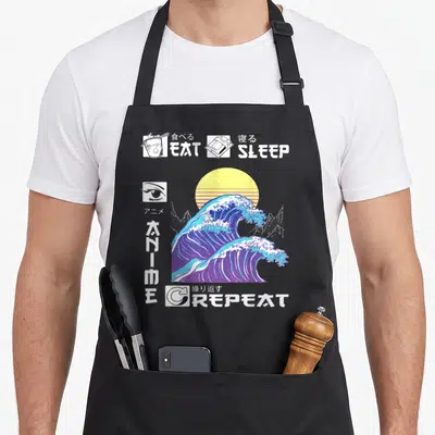 Tablier de cuisine noir avec une grande onde bleue, un soleil jaune et les mots EAT SLEEP REPEAT en blanc.