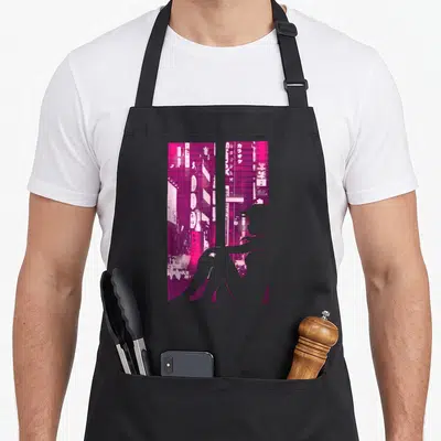 Tablier de cuisine noir avec silhouette rose d'une Cyberpunk Girl devant des néons japonais et du texte en caractères orientaux.
