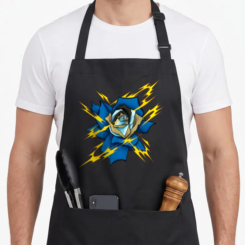 Tablier de cuisine noir avec une rose bleue aux éclairs jaunes et un visage stylisé au centre.