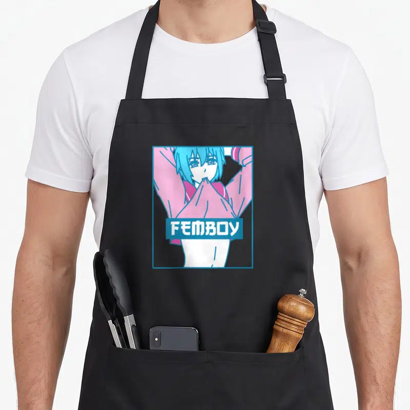 Tablier de cuisine noir avec illustration d'un personnage aux cheveux bleus et le mot FEMBOY en lettres blanches sur fond bleu.