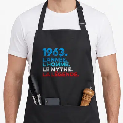 Tablier de cuisine noir avec l inscription 1963 l année le mythe la légende en bleu et rouge.