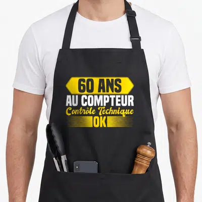 Tablier de cuisine noir avec inscription jaune et blanche 60 ans au compteur contrôle technique ok.