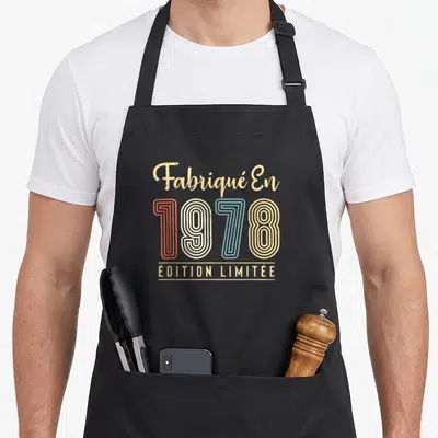 Tablier de cuisine noir avec inscription vintage « Fabriqué En 1978 Édition Limitée » en couleurs pastel et texte doré.