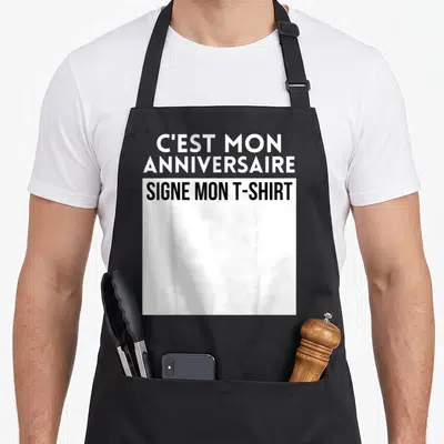 Tablier de cuisine noir avec le texte blanc C'est mon anniversaire et noir signe mon « t-shirt » imprimé au centre.