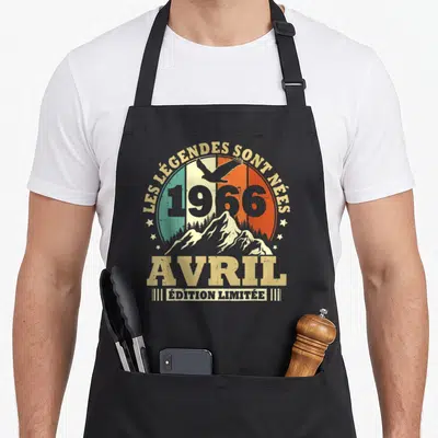 Tablier de cuisine noir avec motif vintage montrant des montagnes, un aigle et le texte « Les Légendes sont Nées Avril 1966 Édition Limitée ».