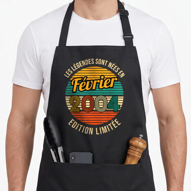 Tablier de cuisine noir avec motif circulaire rétro coloré affichant Février 2004 et Edition Limitée en typographie vintage.
