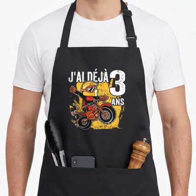 Tablier de cuisine noir avec illustration de pilote de motocross et texte J'ai déjà 3 ans.