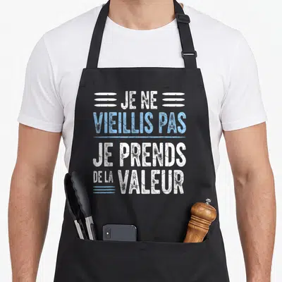 Tablier de cuisine noir avec inscription blanche et bleue Je ne vieillis pas je prends de la valeur.